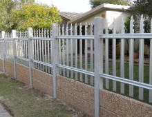 Palisade fence on top of Vibracrete